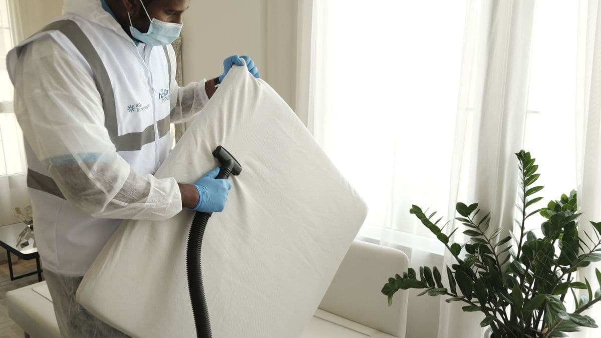 Profissional higienizando e aspirando um colchão
